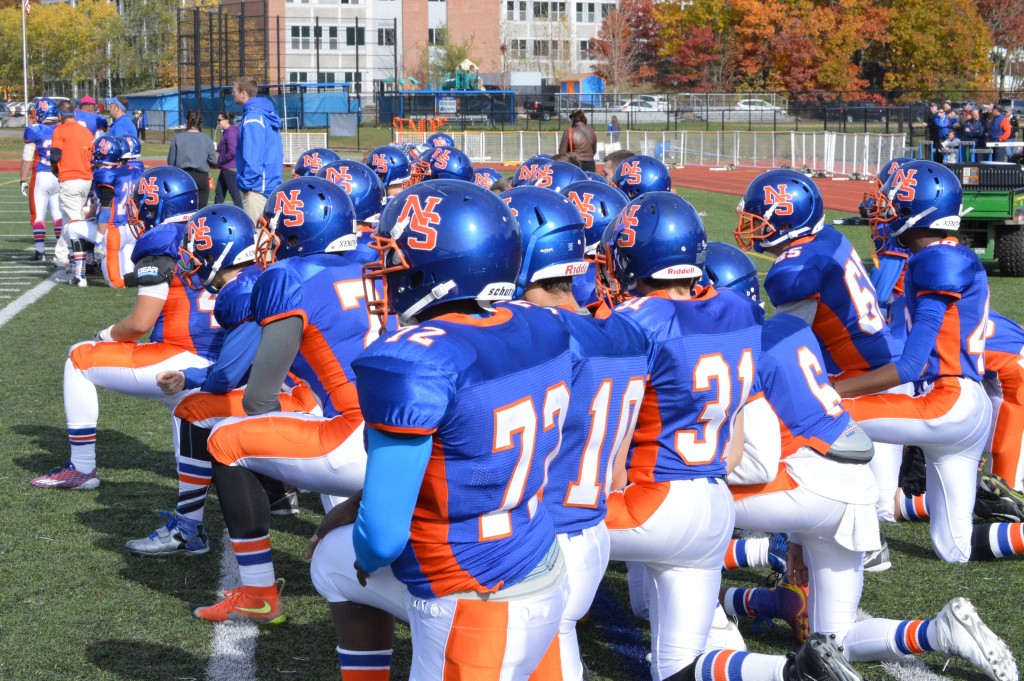 The team takes a knee as the whole stadium seemed to gasp when Burton was injured during the third quarter after an interception. After limping off of the field due to an apparent knee injury, the junior quarterback didn't miss a snap. Photograph by Bailey Kroner